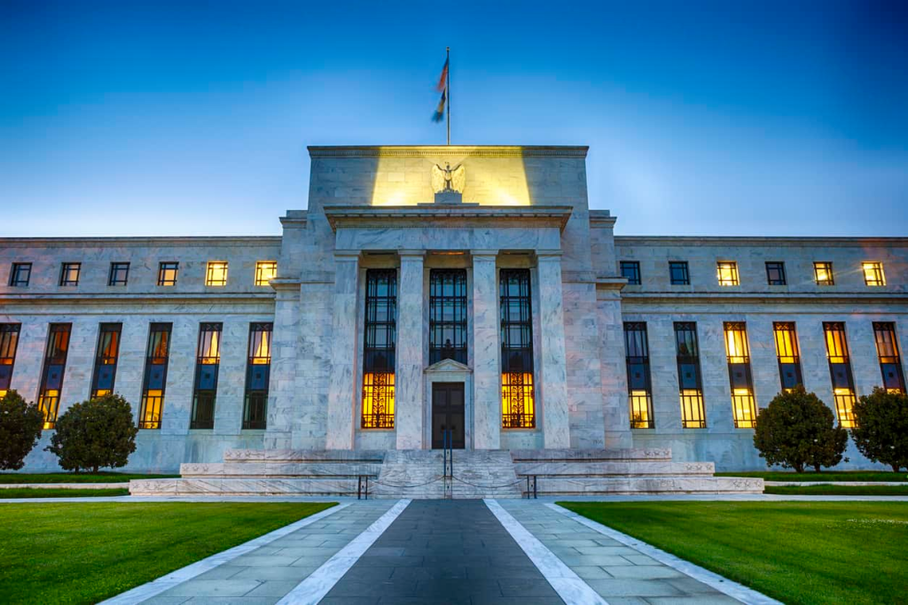 The Federal Reserve building in Washington D.C. illuminated at dusk, symbolizing the central bank of the United States